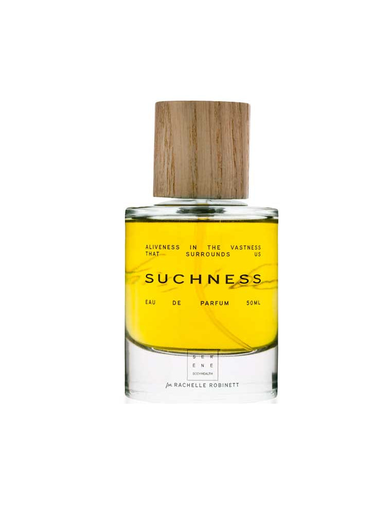 Perfume bottle labeled 'Suchness' with a wooden cap on a white background
