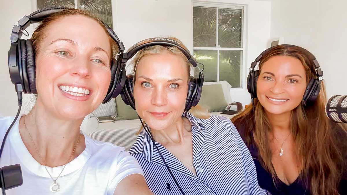 Irene Falcone in a white t-shirt taking a selfie with Fiona Tuck in a blue striped shirt and Lee Holmes, all smiling in headphones in the bright podcast studio
