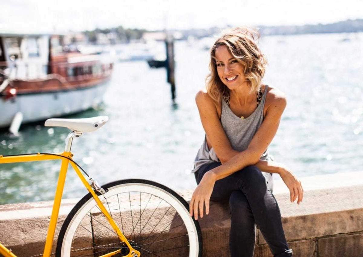 Sarah Wilson, founder of I Quit Sugar, sitting next to her bike