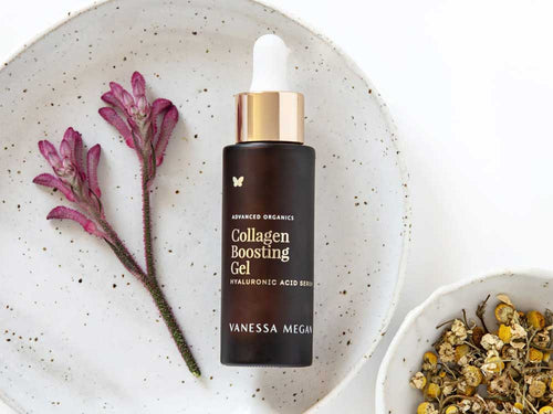 A bottle of Vanessa Megan Advanced Organics Collagen Boosting Gel Hyaluronic Acid Serum on a ceramic plate.