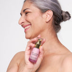 Model holding The Jojoba Company Neck and Decolletage Lifting Concentrate