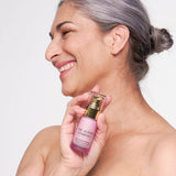 Model holding The Jojoba Company Neck and Decolletage Lifting Concentrate