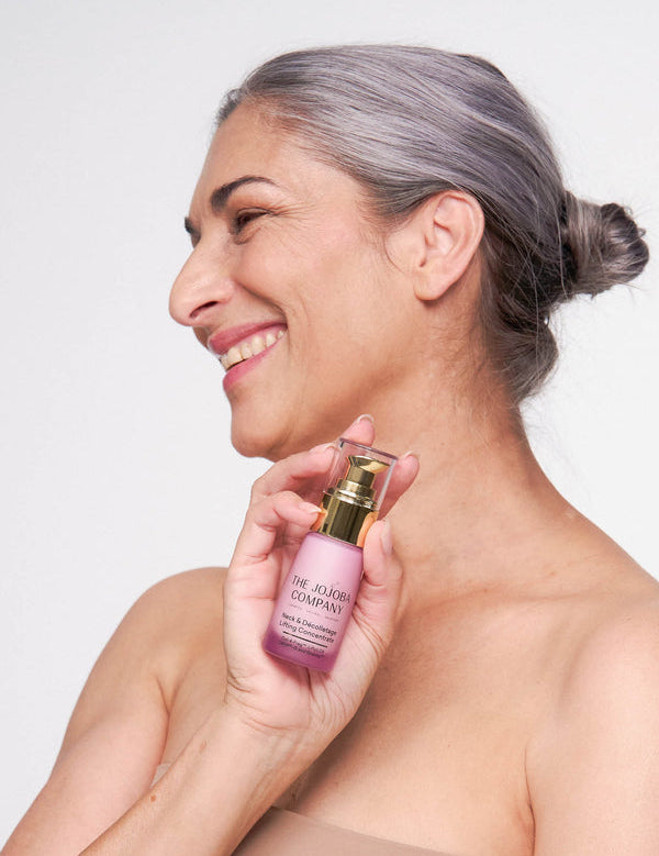 Model holding The Jojoba Company Neck and Decolletage Lifting Concentrate