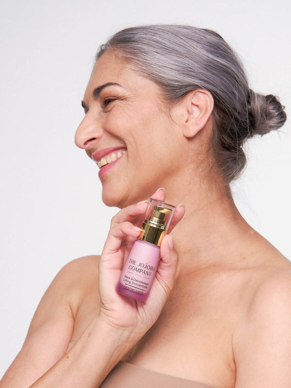Model holding The Jojoba Company Neck and Decolletage Lifting Concentrate