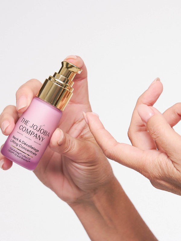 Woman applying The Jojoba Company Neck and Decolletage Lifting Concentrate