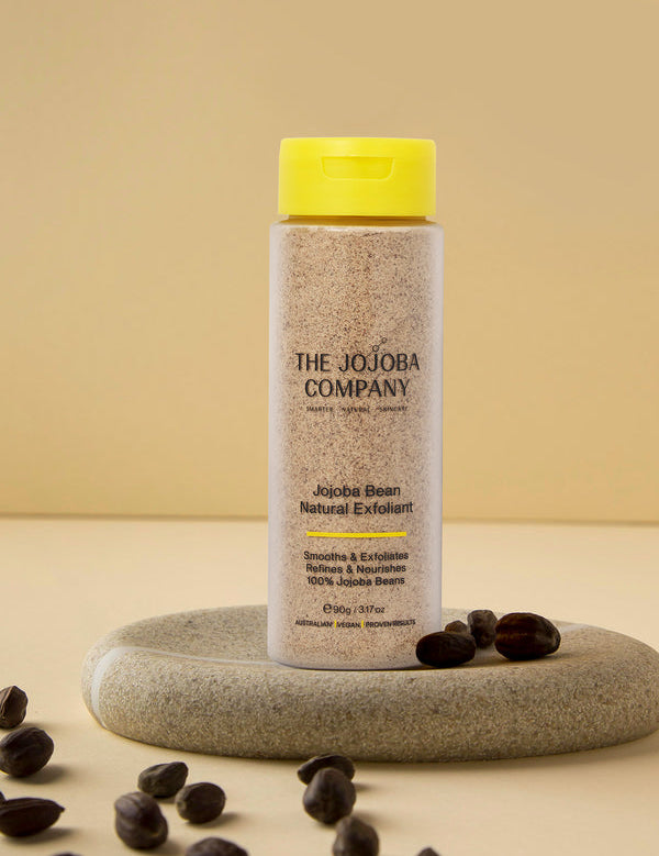 The Jojoba Company Jojoba Bean Natural Exfoliant surrounded by jojoba beans
