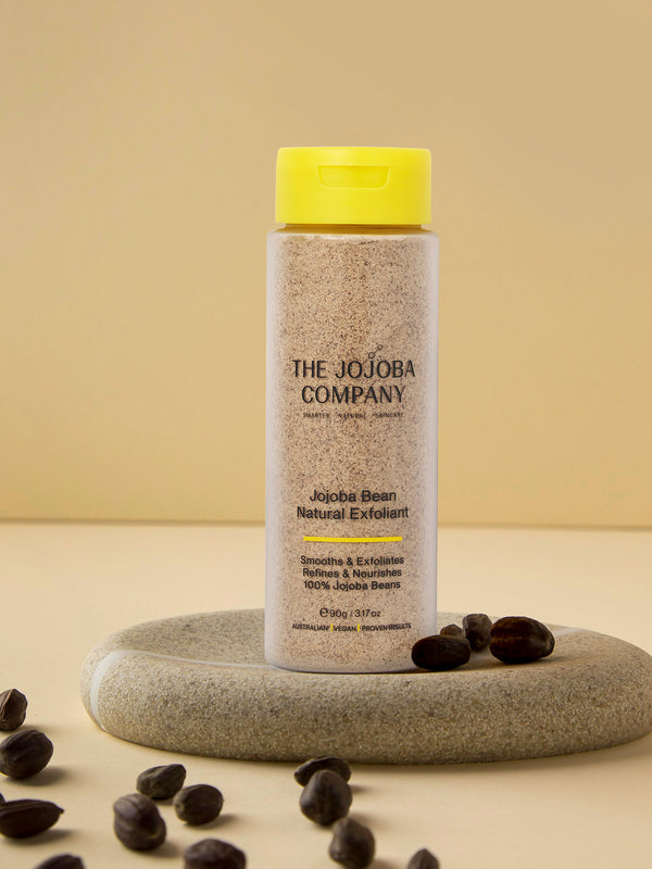 The Jojoba Company Jojoba Bean Natural Exfoliant surrounded by jojoba beans