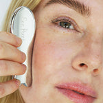 Woman gliding the Ere Perez Steel Face Tool along her cheekbone