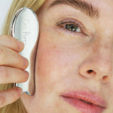 Woman gliding the Ere Perez Steel Face Tool along her cheekbone