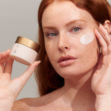 Model applying INIKA Organic Phytofuse Renew Night Cream to her face