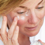 Woman applying Ere Perez Cranberry Lip and Eye Mask under her eyes with her fingertip