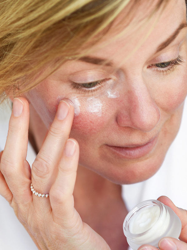 Woman applying Ere Perez Cranberry Lip and Eye Mask under her eyes with her fingertip
