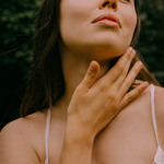 Woman applying Tuttofare Holy Grail Tallow Balm to her neck