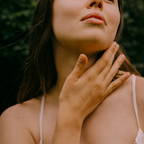 Woman applying Tuttofare Holy Grail Tallow Balm to her neck