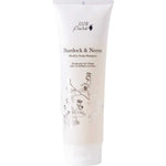 A white tube of 100% Pure Burdock and Neem Healthy Scalp Shampoo by 100% Pure displays floral illustrations and a minimalist, elegant front design.