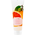 A white tube labeled 100% Pure Yuzu & Pomelo Glossing Shampoo, featuring grapefruit and green leaves images, plus pink text highlighting its natural formula.