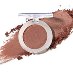 100% Pure Fruit Pigmented Eye Shadow in Cinnaban, showing an open compact beside a sweep of matching loose powder on white, with the shade name Cinnaban printed below.