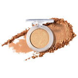 100% Pure Fruit Pigmented Eye Shadow in Gilded, showing an open compact beside a sweep of matching loose powder on white, with the shade name Gilded printed below.