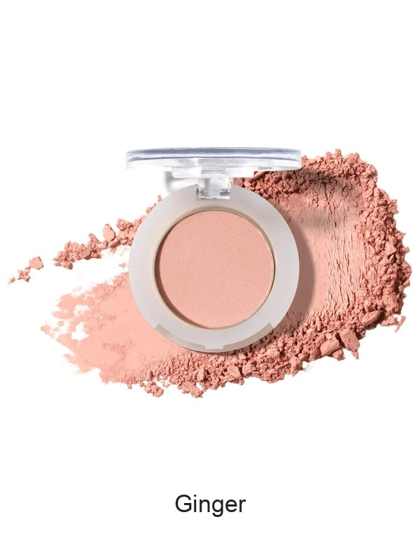100% Pure Fruit Pigmented Eye Shadow in Ginger, showing an open compact beside a sweep of matching loose powder on white, with the shade name Ginger printed below.