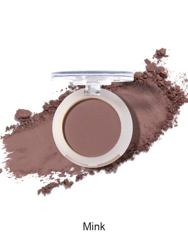 100% Pure Fruit Pigmented Eye Shadow in Mink, showing an open compact beside a sweep of matching loose powder on white, with the shade name Mink printed below.