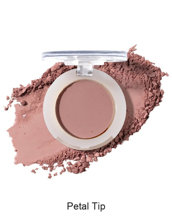 100% Pure Fruit Pigmented Eye Shadow in Petal Tip, showing an open compact beside a sweep of matching loose powder on white, with the shade name Petal Tip printed below.