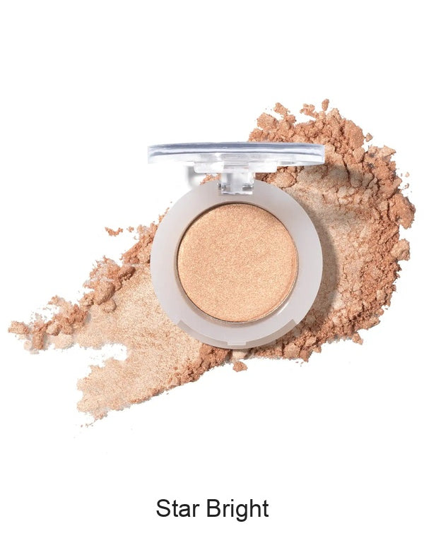 100% Pure Fruit Pigmented Eye Shadow in Star Bright, showing an open compact beside a sweep of matching loose powder on white, with the shade name Star Bright printed below.