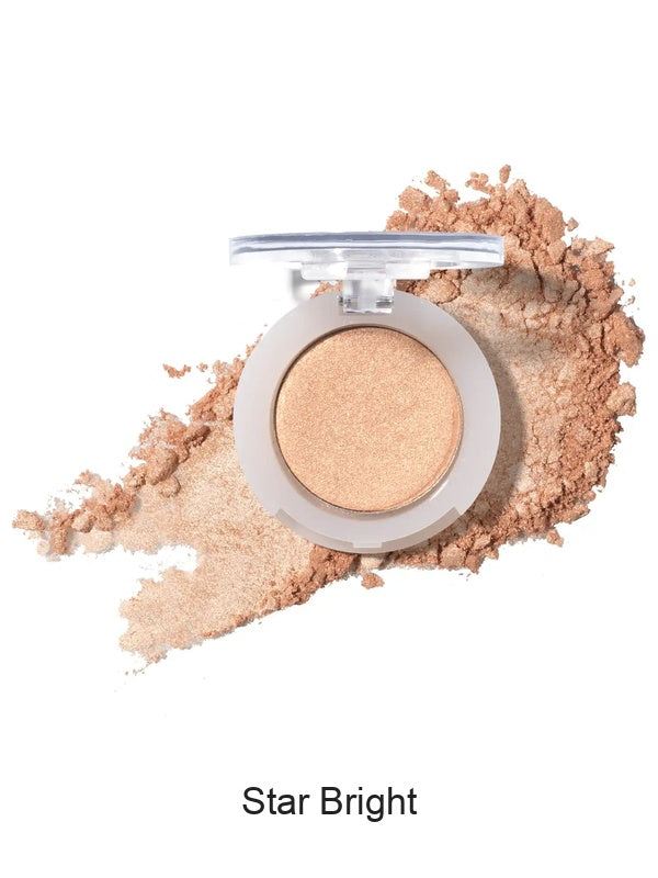 100% Pure Fruit Pigmented Eye Shadow in Star Bright, showing an open compact beside a sweep of matching loose powder on white, with the shade name Star Bright printed below.