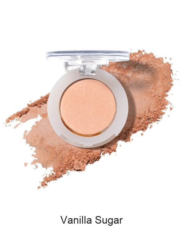 100% Pure Fruit Pigmented Eye Shadow in Vanilla Sugar, showing an open compact beside a sweep of matching loose powder on white, with the shade name Vanilla Sugar printed below.