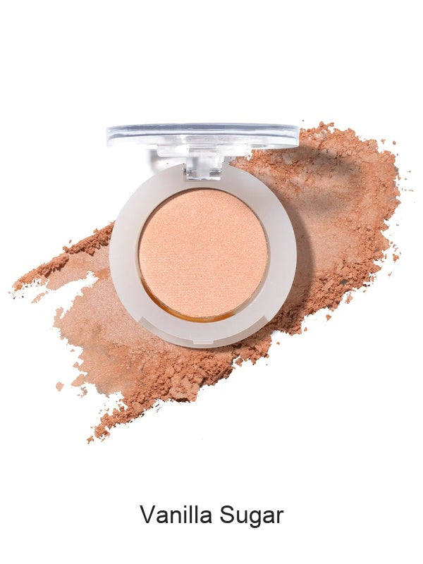 100% Pure Fruit Pigmented Eye Shadow in Vanilla Sugar, showing an open compact beside a sweep of matching loose powder on white, with the shade name Vanilla Sugar printed below.