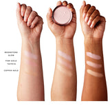 Three forearms with light, medium and dark skin show Gemmed Luminiser swatches. From wrist towards elbow: Moonstone Glow, pearly pink; Pink Gold Taffeta, rosy gold; Copper Gold, warm gold. The middle hand holds a compact. Shade codes: Moonstone Glow 1CFPMGL, Pink Gold Taffeta 1CFPPCL, Copper Gold 1CFPRGL.