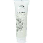 A white tube of 100% Pure Kelp & Mint Volumising Shampoo features botanical artwork and green lettering, highlighting its natural thickening formula.