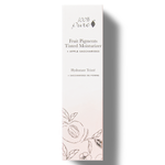 A tall white 100% Pure Tinted Moisturiser carton with black lettering, an apple saccharides label and delicate fruit and leaf drawings around the pale pink base.