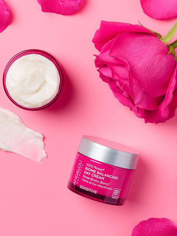 Andalou 1000 Roses Biome Balancing Day Cream styled with rose petals