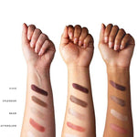 Three forearms displaying the 100% Pure Berry Naked Palette shades as skin swatches across different skin tones.