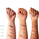 Three forearms in various skin tones display five swatches from the 100% Pure Better Naked Palette 9g—Butterfly, Bear, Kitty, Bunni, and Fox—highlighting these vegan nude eyeshadow shades on different complexions.