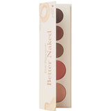 The 100% Pure Better Naked Palette 9g is open, showing five vegan eyeshadow and blush shades in neutral and peach tones. The light, minimal packaging features subtle fruit illustrations and a clean design.