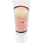 A white squeeze tube of 100% Pure Coconut Buttercream Hand Cream 57g with a pink label features English and French text, plus a coconut shell band near the top, emphasizing deep moisture for your hands.
