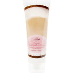 A 236ml tube of 100% Pure Coconut Nourishing Body Cream, a vegan lotion with a white cap and label featuring pink and brown accents, coconut imagery, and product details.