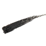 A single black brushstroke of 100% Pure Creamy Long Last Liner 1.14g, by 100% Pure, appears creamy and textured on a white background with a slightly uneven finish.