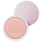 A light pink, round compact from 100% Pure featuring an embossed floral lid opens to reveal the Fruit Pigmented® Gemmed Luminiser 9g, a glow powder with a leaf motif and the 100% Pure logo.