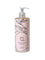 A bottle of 100% Pure Glossy Locks Moisture Drench Shampoo for dry hair, with a pink label featuring a line drawing of a peach and leaves, and a pump dispenser.