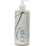 A bottle of 100% Pure Glossy Locks Repair Shampoo with a pump dispenser features the 100% Pure brand, minimalist hairline artwork, and black, brown, and pink text on a white label.