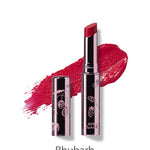 A metallic tube of 100% Pure Fruit Pigmented® Lip Glaze 2.5g by 100% Pure, featuring a floral design and deep red Rhubarb shade. A color swatch is displayed behind the tube on a white background.