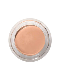 A top view of the 100% Pure Fruit Pigmented® Long Last Concealer with Super Fruits 3g by 100% Pure, a light beige vegan formula in a clear round jar with a silver rim—ideal for achieving a flawless finish.