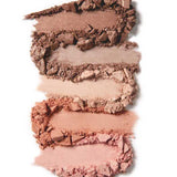 Four smudged and crushed powders from the 100% Pure Pretty Naked Palette 9g in brown and pink shades are arranged vertically on a white background, highlighting this versatile neutral eyeshadow palette.