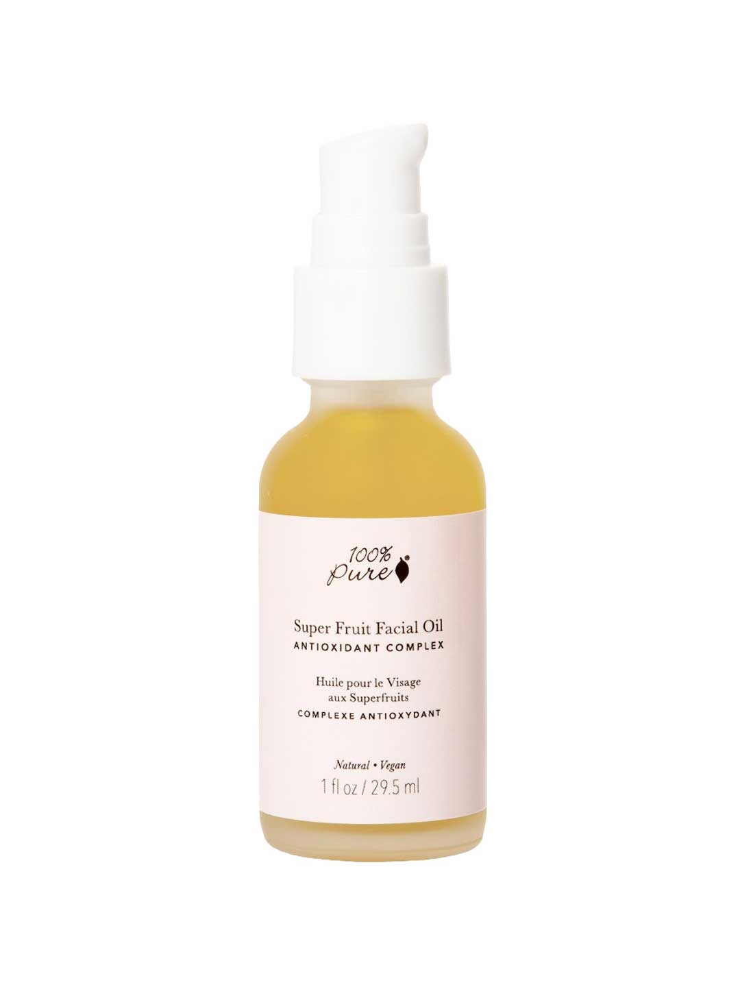 A glass pump bottle with a white label contains 100% Pure Super Fruit Facial Oil 29.5ml—an all-natural, vegan formula rich in antioxidants and pomegranate seed oil.