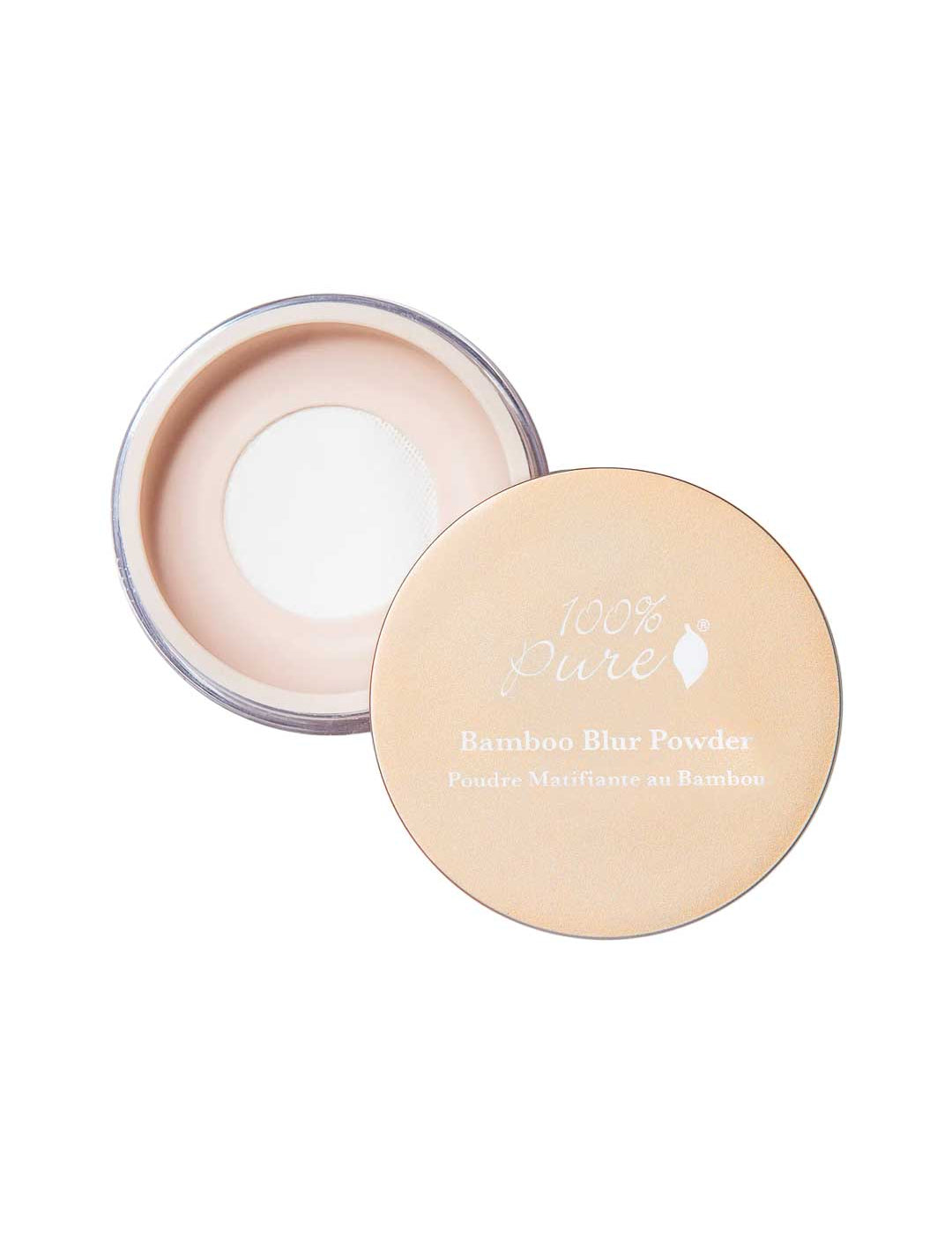 An open container of 100% Pure Translucent Bamboo Blur Powder 5.5g with its beige lid placed beside it reveals the light beige loose powder inside; the lid displays the product name in white text.