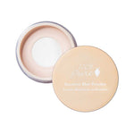 An open container of 100% Pure Translucent Bamboo Blur Powder 5.5g with its beige lid placed beside it reveals the light beige loose powder inside; the lid displays the product name in white text.