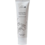 A white tube of 100% Pure Fermented Rice Water Cleanser 100ml, featuring minimalist black text and a rice stalk illustration, stands upright on a white background—ideal for brightening and targeting hyperpigmentation.