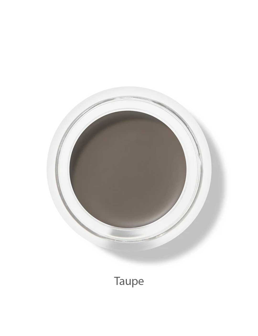 A small round pot of 100% Pure Long Last Brows 4.5g by 100% Pure, filled with taupe long-lasting cream, is viewed from above. The word "Taupe" appears below the container on a white background.